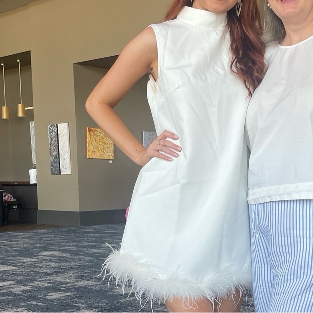 60s style white cocktail with feathers